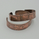 side of two examples of 1/2 inch wide petroglyph copper cuffs.