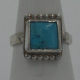 Close up view of turquoise small handmade sterling silver ring